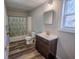 Bathroom featuring a vanity, toilet, and tub with a leafy shower curtain at 2639 Central Ave, Anderson, IN 46016