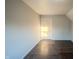 A bedroom with hardwood floors and a door in the corner at 2639 Central Ave, Anderson, IN 46016