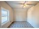 Bedroom features geometric floor tiles, a ceiling fan, and a bright window at 2639 Central Ave, Anderson, IN 46016
