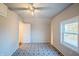 Bedroom features geometric floor tiles, a ceiling fan, and a bright window at 2639 Central Ave, Anderson, IN 46016