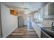 A kitchen with white cabinets, wood flooring, and stainless steel refrigerator at 2639 Central Ave, Anderson, IN 46016