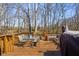 Wooden deck with glass table, chairs, and wooded backdrop at 2895 Prairie Stream Way, Columbus, IN 47203