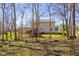 The back of the house shows a deck with wooden stairs descending into a naturally landscaped backyard at 2895 Prairie Stream Way, Columbus, IN 47203