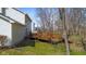 Spacious backyard with a wooden deck, grass, and trees at 2895 Prairie Stream Way, Columbus, IN 47203