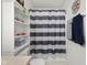 Bright bathroom with striped shower curtain and ample shelving at 2895 Prairie Stream Way, Columbus, IN 47203