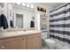 Neutral bathroom with vanity, updated sink, and decorative striped shower curtain at 2895 Prairie Stream Way, Columbus, IN 47203