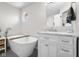 Bright bathroom featuring a standalone tub, window, and marble-topped vanity at 2895 Prairie Stream Way, Columbus, IN 47203