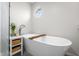 Bathroom featuring a standalone tub, a faucet and a decorative plant at 2895 Prairie Stream Way, Columbus, IN 47203