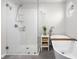 Bathroom featuring a standalone tub, glass shower, and a decorative plant at 2895 Prairie Stream Way, Columbus, IN 47203