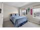 Cozy bedroom with blue bedding, natural light, and sport decor at 2895 Prairie Stream Way, Columbus, IN 47203