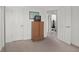 Bedroom with armoire, doorways and neutral-toned carpet at 2895 Prairie Stream Way, Columbus, IN 47203