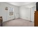 Sunlit bedroom with neutral carpet, window, and simple decor at 2895 Prairie Stream Way, Columbus, IN 47203