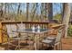 Outdoor wooden deck furnished with table, chairs, and decorative pineapples surrounded by a wooded area at 2895 Prairie Stream Way, Columbus, IN 47203