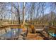 An elevated wooden deck features outdoor seating and a planter box with views of the wooded property at 2895 Prairie Stream Way, Columbus, IN 47203