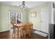 Cozy dining area with hardwood floors, a sliding glass door to the deck, and a classic chandelier at 2895 Prairie Stream Way, Columbus, IN 47203