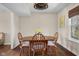 Dining room with wood table and chairs plus view of the landscaped front yard at 2895 Prairie Stream Way, Columbus, IN 47203