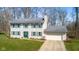 Two-story traditional home with green shutters, a well-manicured lawn, and an attached garage at 2895 Prairie Stream Way, Columbus, IN 47203