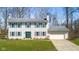 Charming two-story home with a well-kept lawn, green shutters, and an attached garage in a suburban setting at 2895 Prairie Stream Way, Columbus, IN 47203