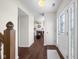 Inviting foyer with hardwood floors, white trim, and a view into the living room with a fireplace at 2895 Prairie Stream Way, Columbus, IN 47203