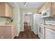 Traditional kitchen featuring wooden cabinets, modern appliances, and a view to an adjacent dining area at 2895 Prairie Stream Way, Columbus, IN 47203