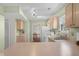 Traditional kitchen featuring wooden cabinets, modern appliances, and a view to an adjacent dining area at 2895 Prairie Stream Way, Columbus, IN 47203