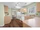 Traditional kitchen featuring wooden cabinets, modern appliances, and a view to an adjacent dining area at 2895 Prairie Stream Way, Columbus, IN 47203