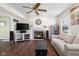 Inviting living room with a fireplace, neutral decor, hardwood floors, and an open floorplan at 2895 Prairie Stream Way, Columbus, IN 47203