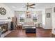 Inviting living room with a fireplace, neutral decor, hardwood floors, and natural light from surrounding windows at 2895 Prairie Stream Way, Columbus, IN 47203