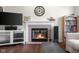 Bright living room featuring a fireplace, hardwood floors, and open layout at 2895 Prairie Stream Way, Columbus, IN 47203