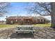 An inviting brick home features a lovely wooden deck with a pergola and picnic table, perfect for outdoor gatherings at 298 Northridge Dr, Mooresville, IN 46158