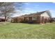 The side of the home showcases a well-maintained lawn and a charming pergola-covered deck at 298 Northridge Dr, Mooresville, IN 46158