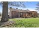 The brick house features a wooden deck with a pergola and convenient ramp access, surrounded by green lawns at 298 Northridge Dr, Mooresville, IN 46158