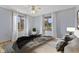 Serene bedroom featuring a comfortable bed, ceiling fan and bright windows with views of the outdoors at 298 Northridge Dr, Mooresville, IN 46158