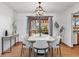 Elegant dining room with a marble table, modern lighting, and sliding doors to the backyard at 298 Northridge Dr, Mooresville, IN 46158