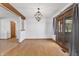Open dining room featuring wood floors, modern light fixture, and large sliding glass doors to the outdoors at 298 Northridge Dr, Mooresville, IN 46158