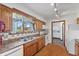 Traditional kitchen with wood cabinets, double stainless sink, and window overlooking the yard at 298 Northridge Dr, Mooresville, IN 46158