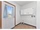Functional laundry room with linoleum floors, white cabinets, and exterior access at 298 Northridge Dr, Mooresville, IN 46158