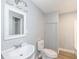 Bathroom featuring a white sink, toilet, and mirror at 315 S Parkway Dr, Anderson, IN 46013