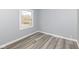 Bright bedroom with a large window, gray walls, and light wood flooring at 315 S Parkway Dr, Anderson, IN 46013