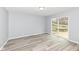 This bedroom features durable gray flooring, sliding glass door providing natural light, and base trim at 315 S Parkway Dr, Anderson, IN 46013