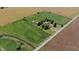 A high view of the house and barn set amongst farm land, driveways and mature trees at 3451 N County Road 100 E, Danville, IN 46122