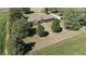 Aerial shot of a well-maintained home, nestled among mature trees with a sprawling lawn at 3451 N County Road 100 E, Danville, IN 46122