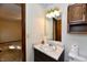Small bath with patterned wallpaper and vanity with marble top, and view to the bedroom at 3451 N County Road 100 E, Danville, IN 46122