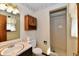 Small bath with patterned wallpaper and vanity with marble top, with a view to the shower at 3451 N County Road 100 E, Danville, IN 46122