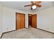 Carpeted bedroom with neutral walls, fan, closet with bi-fold doors, and doorway at 3451 N County Road 100 E, Danville, IN 46122