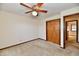 Carpeted bedroom with neutral walls, fan, closet with bi-fold doors, and doorway at 3451 N County Road 100 E, Danville, IN 46122