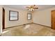 This bright bedroom features neutral walls, carpeted floors, a ceiling fan, and two windows at 3451 N County Road 100 E, Danville, IN 46122
