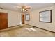 Bright bedroom features neutral walls, carpeted floors, ceiling fan, and two windows at 3451 N County Road 100 E, Danville, IN 46122