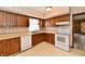 Charming kitchen with wood cabinets, white appliances, and a window above the sink at 3451 N County Road 100 E, Danville, IN 46122
