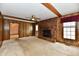 Inviting living room with brick fireplace, wood paneling, ceiling fan and natural light at 3451 N County Road 100 E, Danville, IN 46122